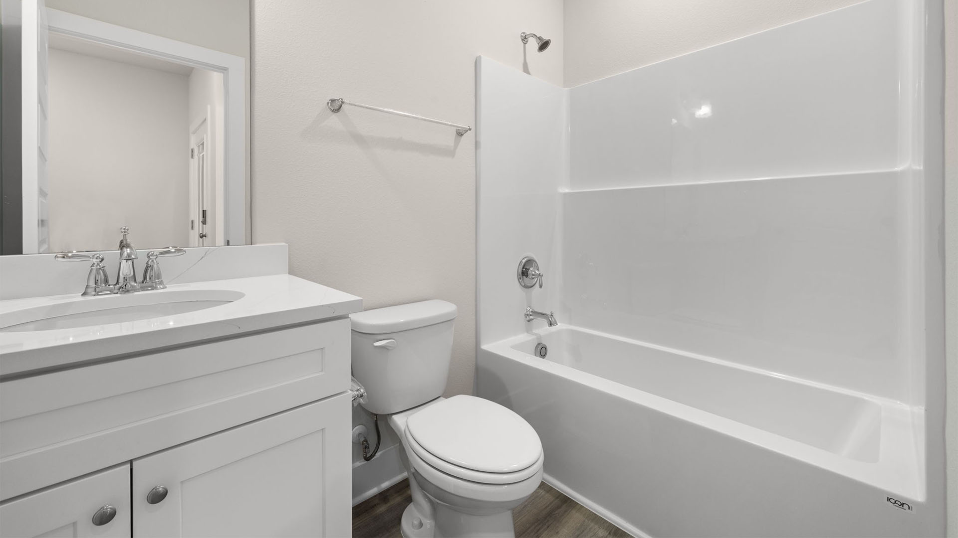 Bathroom with EVP flooring and quartz countertops and single vanity and white cabinets and tub and shower.