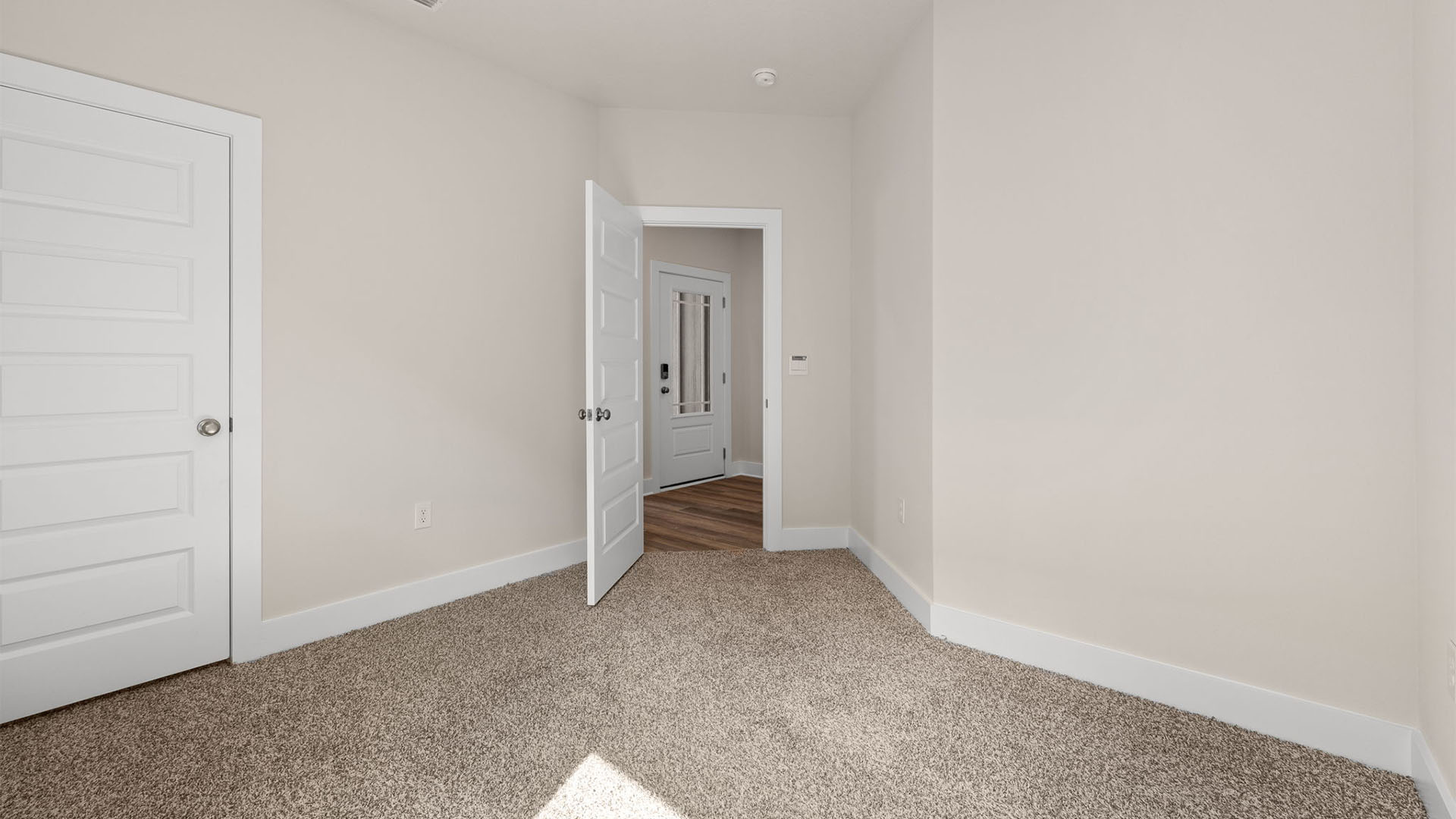Bedroom with carpet flooring and closet.
