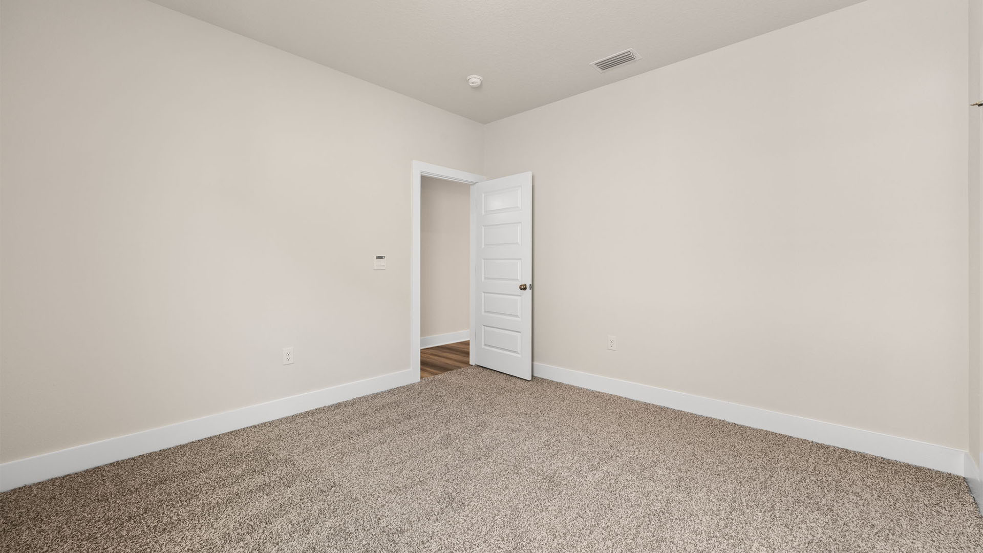 Bedroom with carpet flooring and closet.