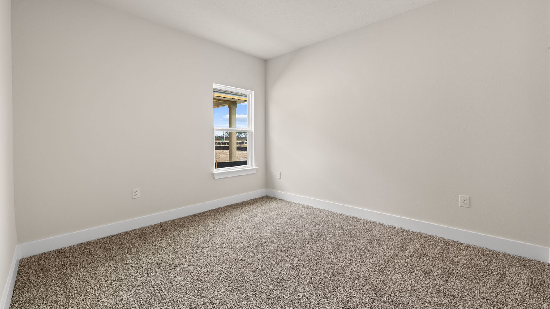 Bedroom with carpet flooring and window.
