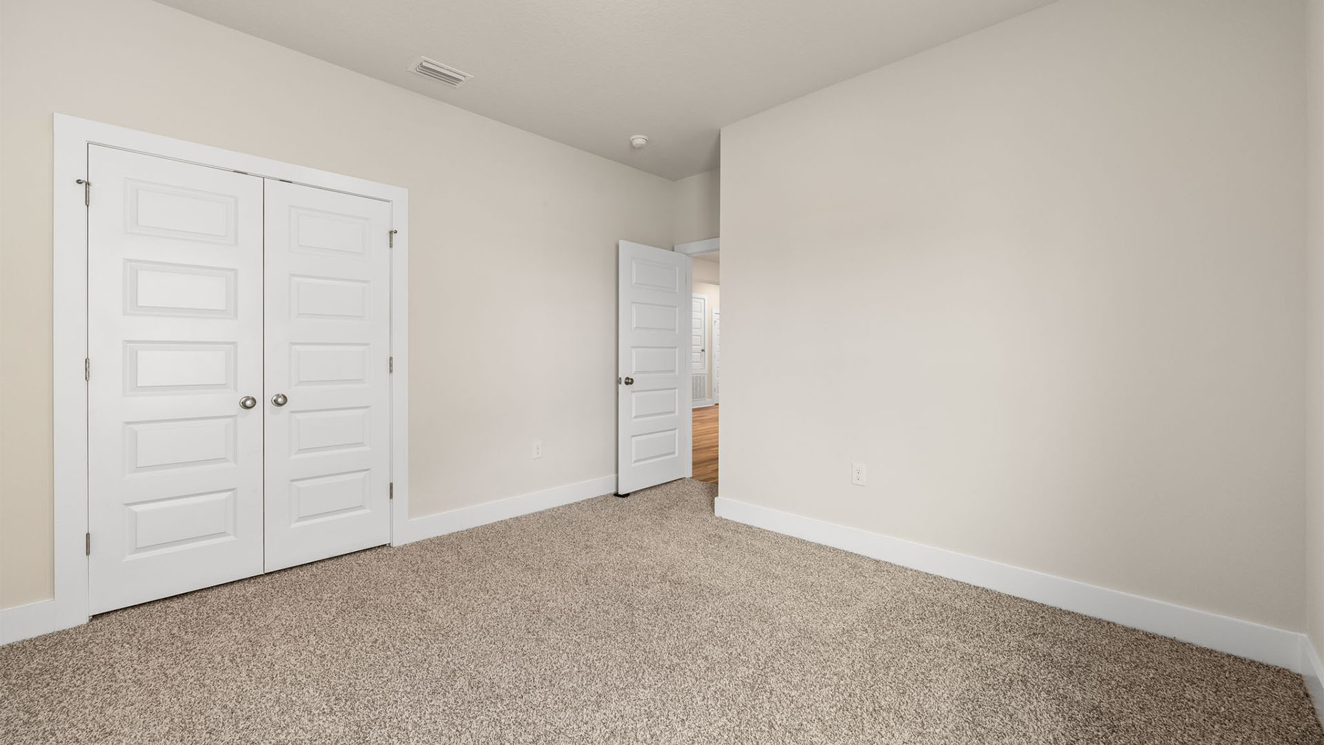 Bedroom with carpet flooring and closet.