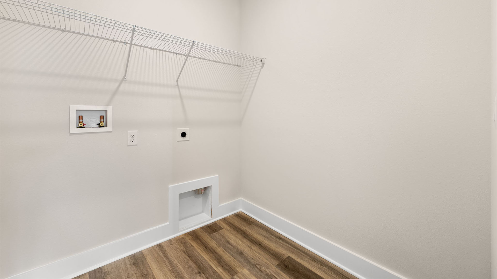 Laundry room with EVP flooring and ventilated shelving.