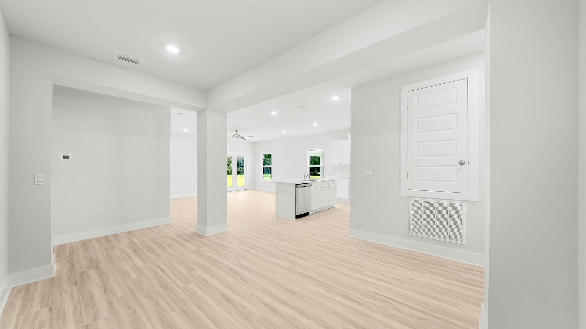 Dining room with EVP flooring and kitchen.
