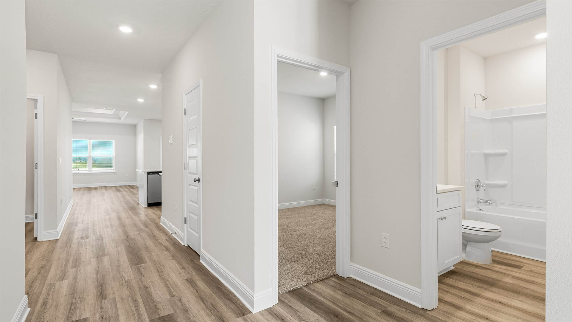 Front hallway with EVP flooring next to bedrooms and guest bathroom.