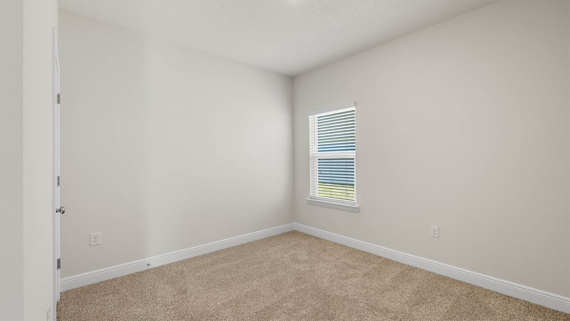 Bedroom with carpet floors and window.