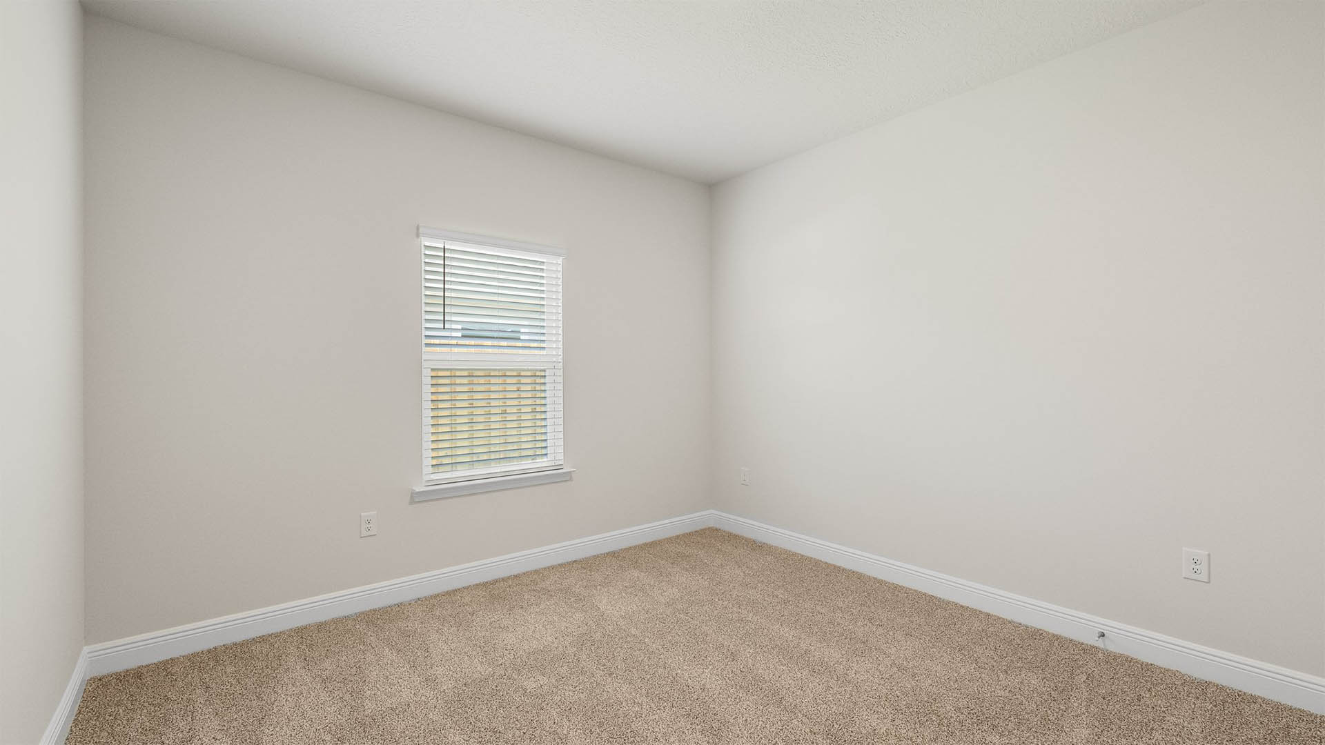 Bedroom with carpet floors and window.