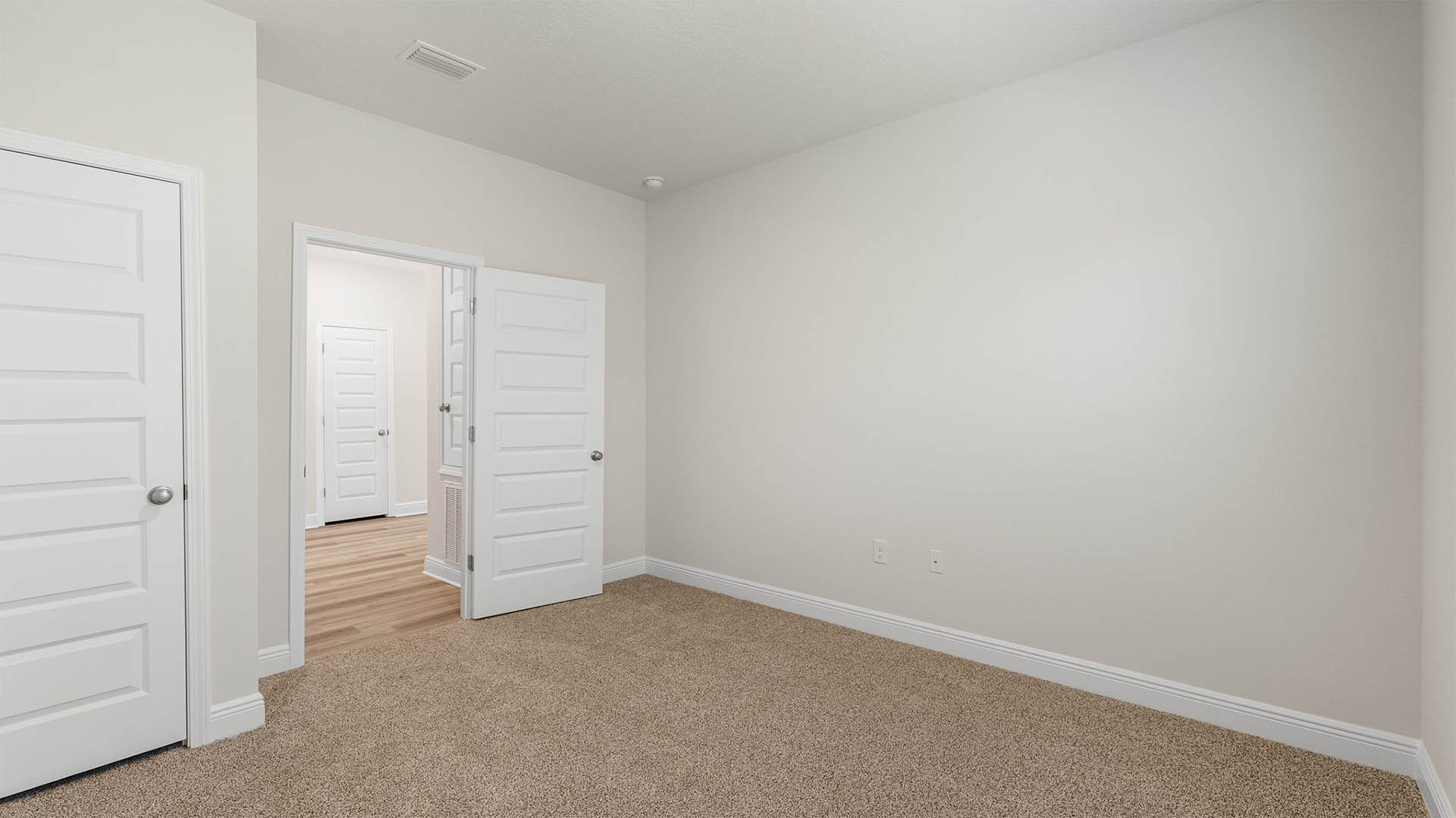 Bedroom with carpet floors and closet.