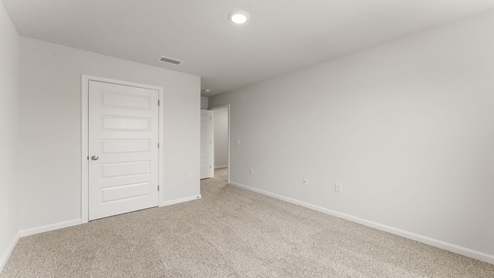 Bedroom with carpet floor and closet.