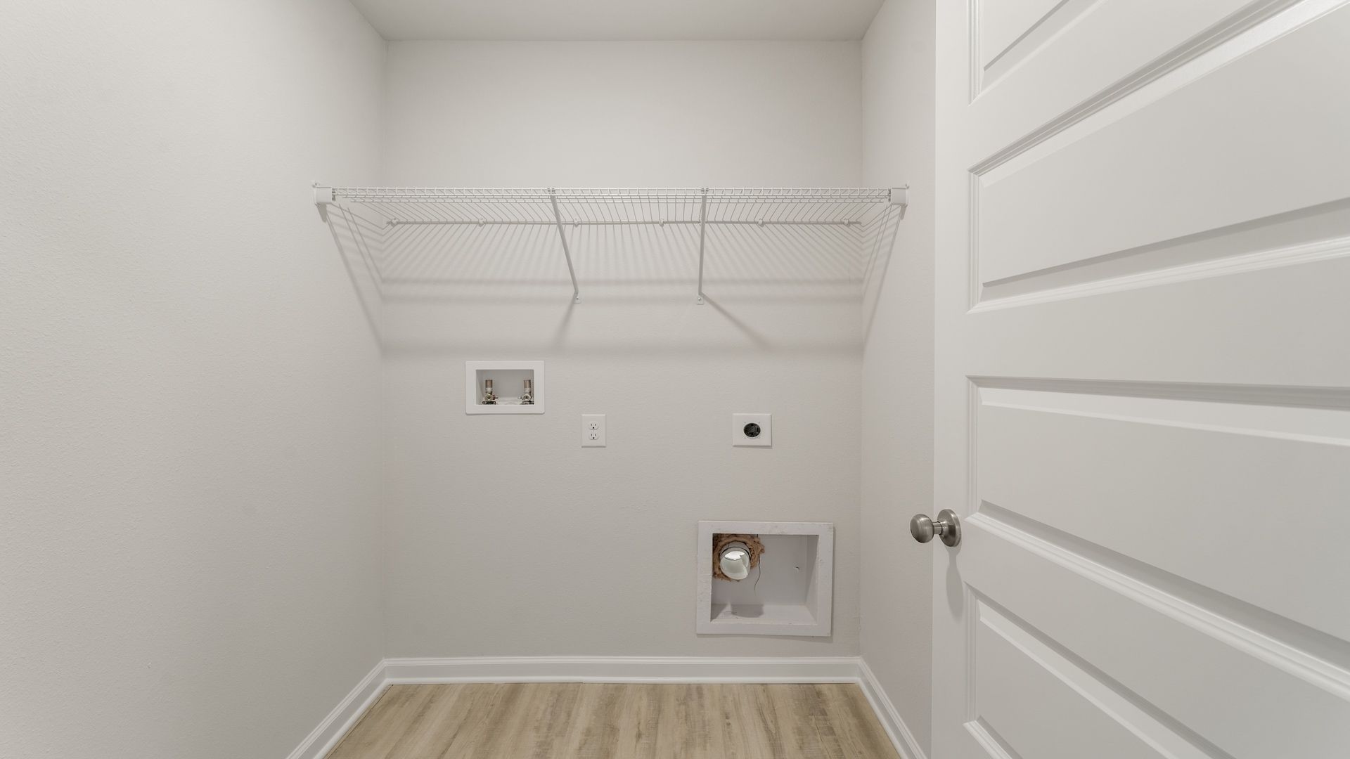 Upstairs laundry room with ventilated shelving.