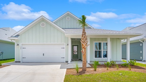 Delray floor plan at WindMark Beach with covered front porch and two car garage and Hardie board siding.