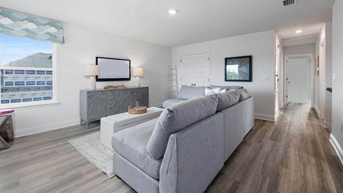 Upstairs common area with window and bedroom entrances.