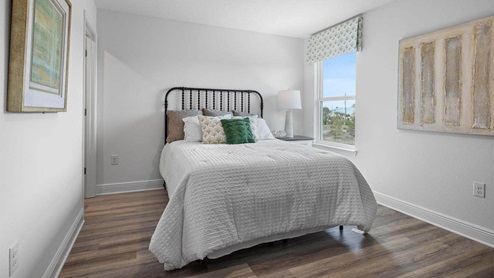 Bedroom with EVP flooring and window.