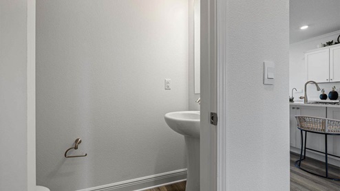 Half bathroom with EVP flooring and sink.