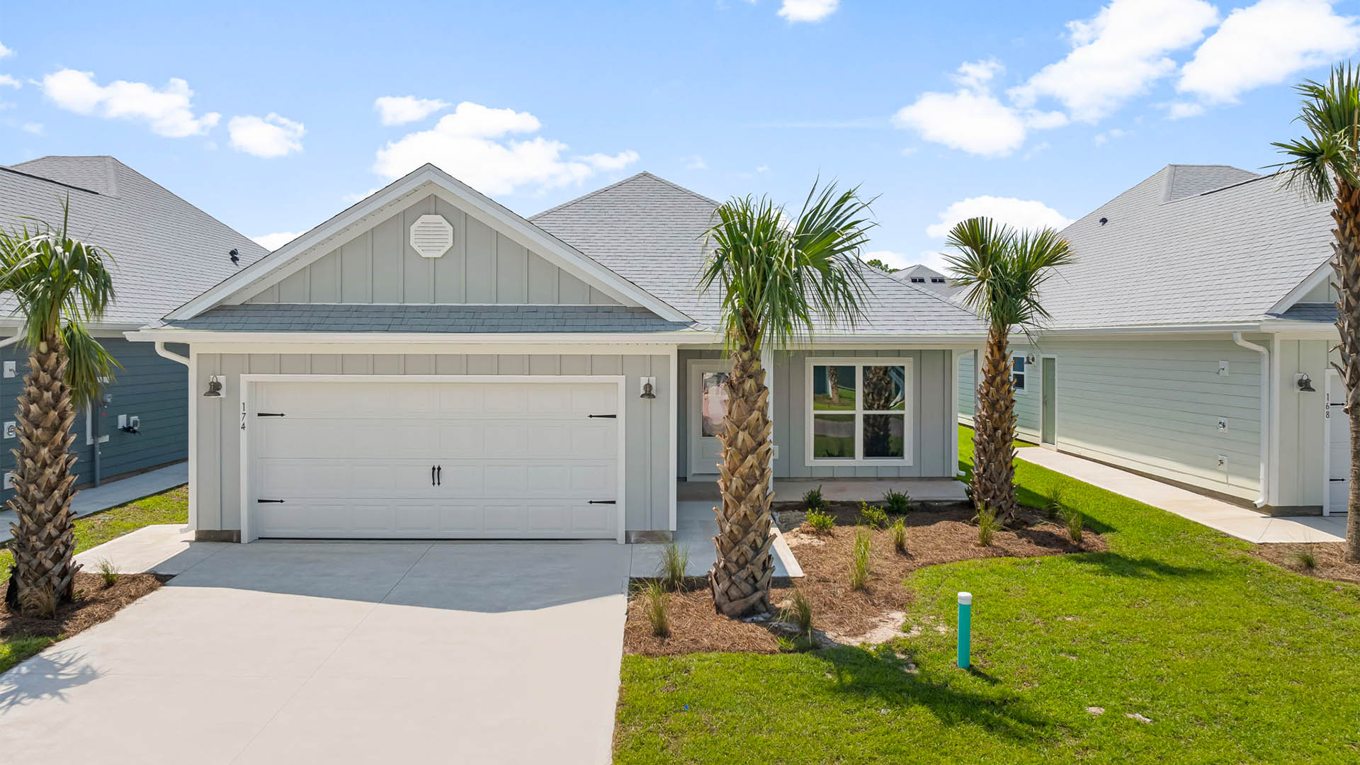 Isabella floor plan at WindMark Beach with covered front porch and two car garage and Hardie board siding.
