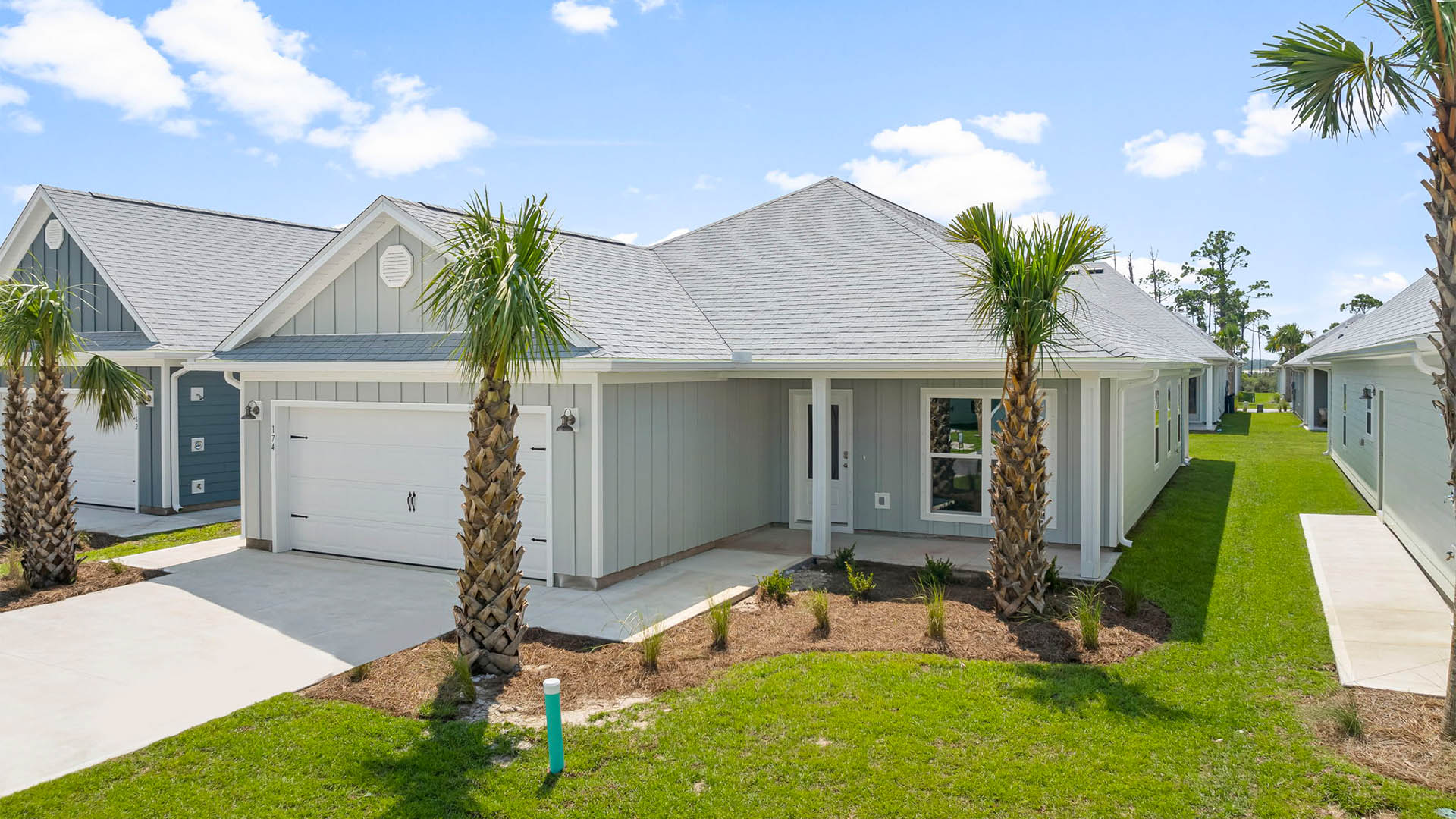 Isabella floor plan at WindMark Beach with covered front porch and two car garage and Hardie board siding.