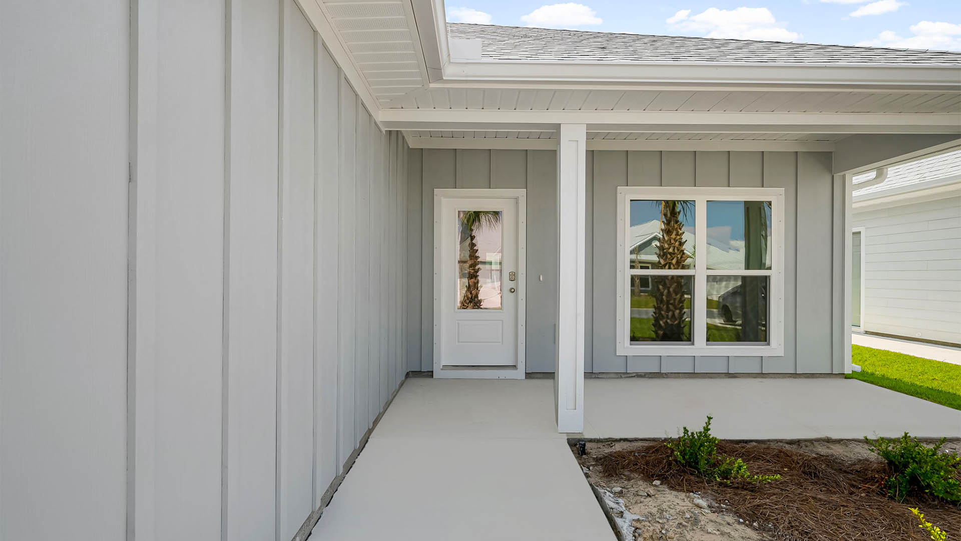 Front walkway with covered front patio and front door.