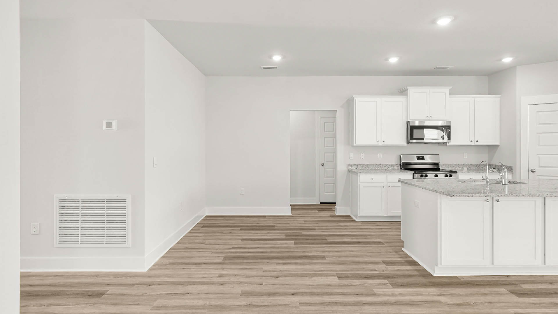 Kitchen and dining room next to bedrooms and hallway.