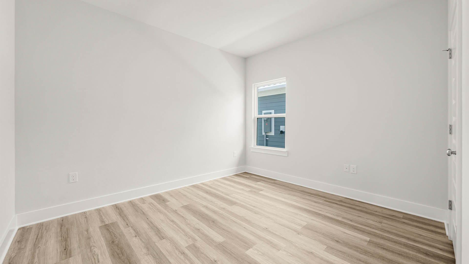 Bedroom with EVP flooring and window.