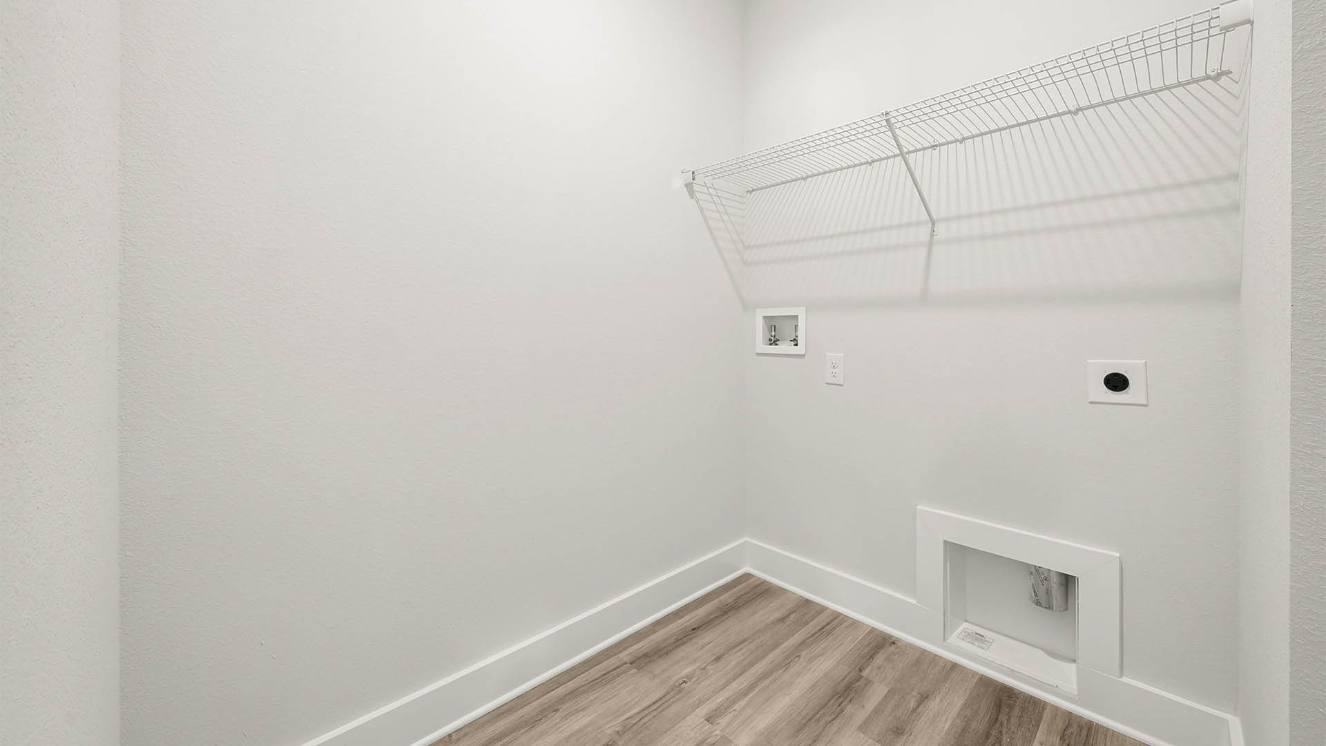 Laundry room with EVP flooring and ventilated shelving.