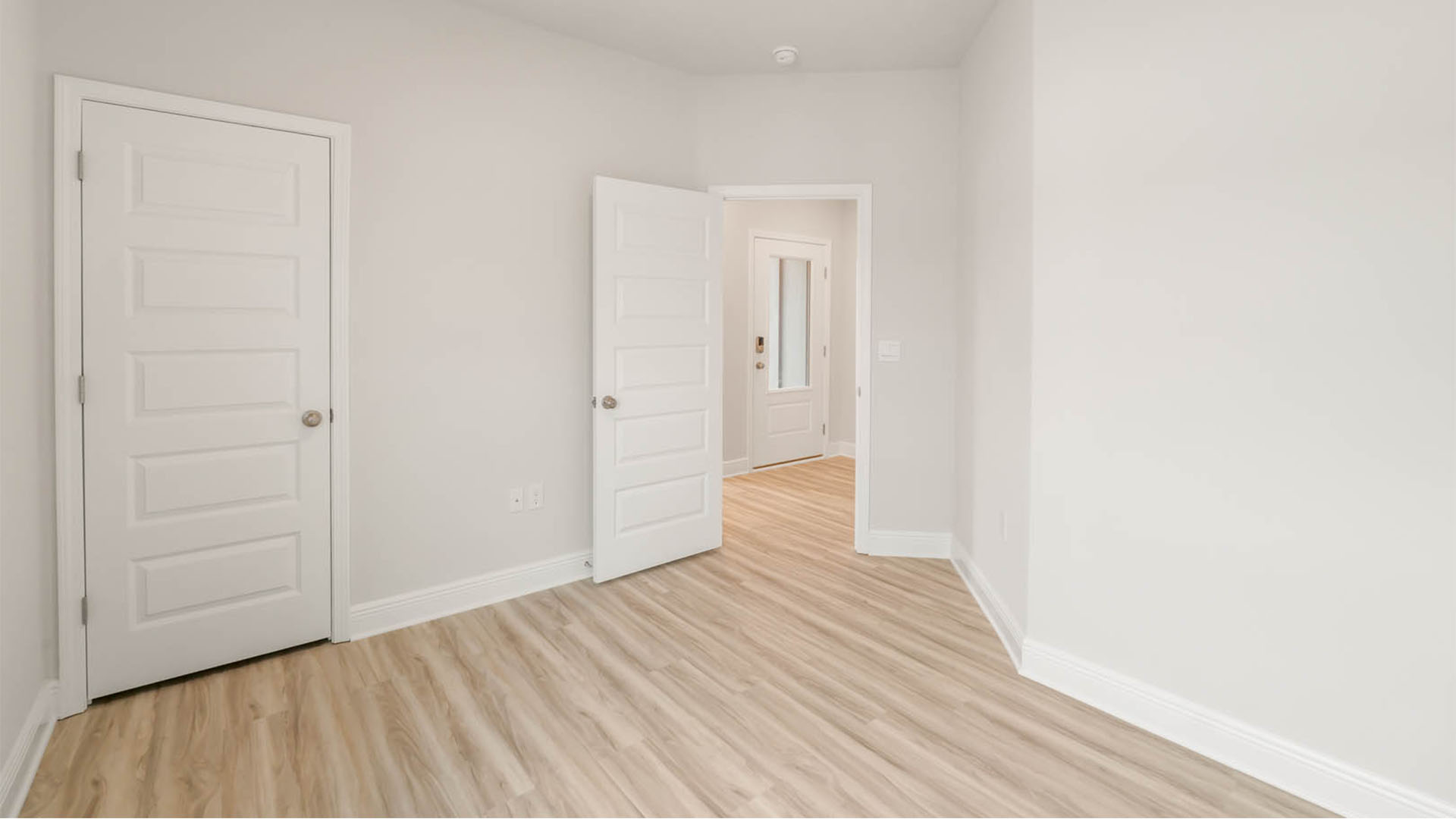 Bedroom with EVP flooring and closet.