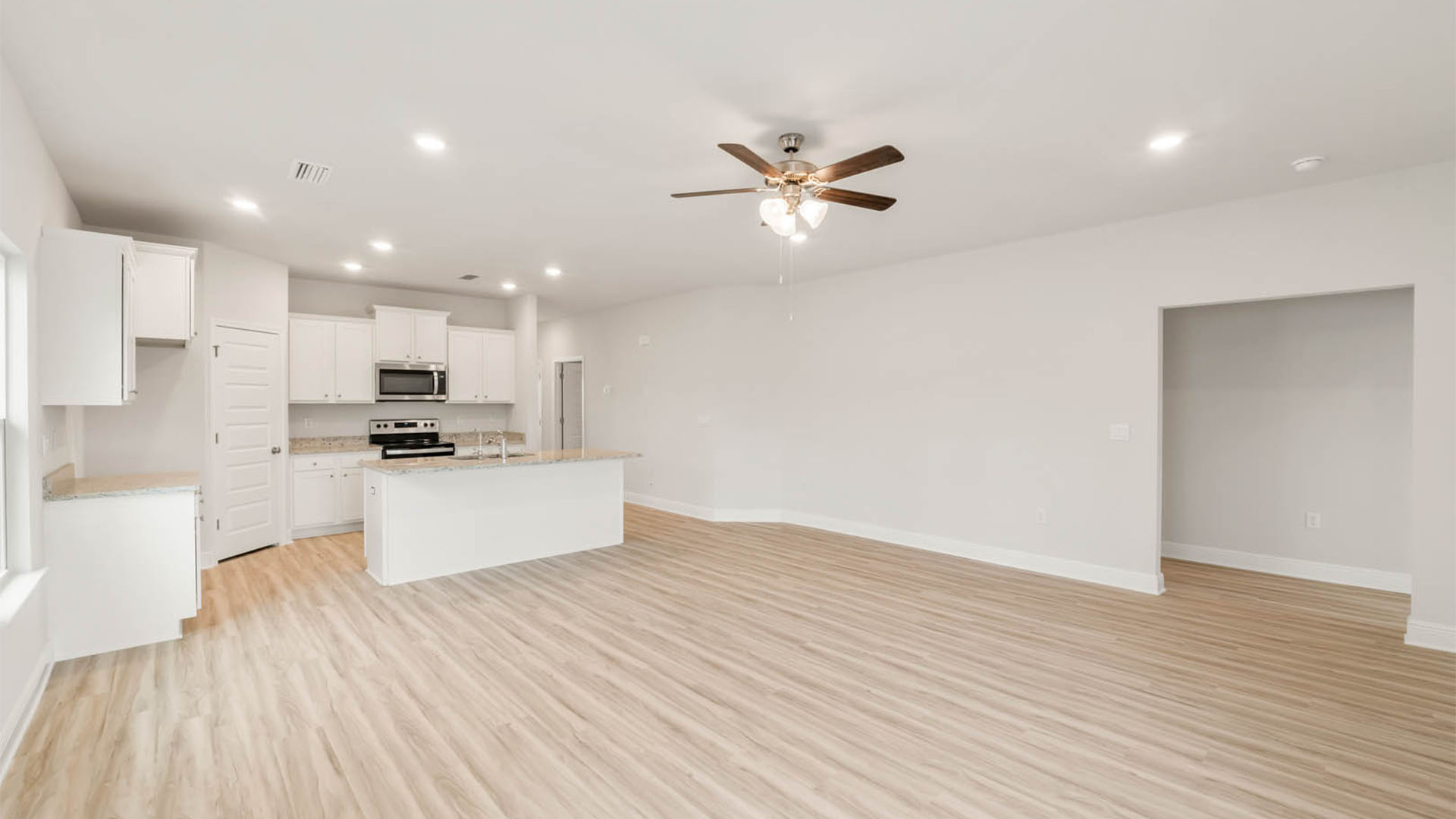 Living room with EVP flooring and ceiling fan.
