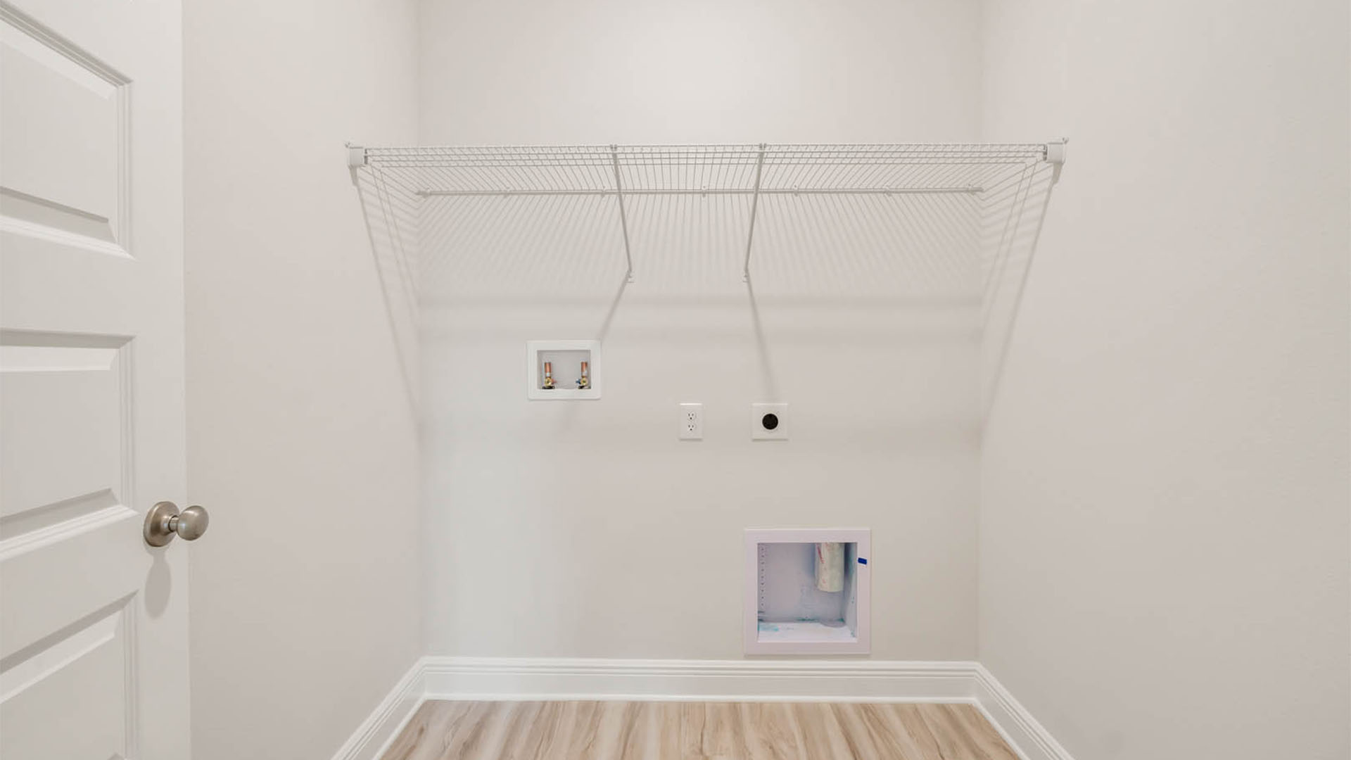 Laundry room with ventilated shelving.