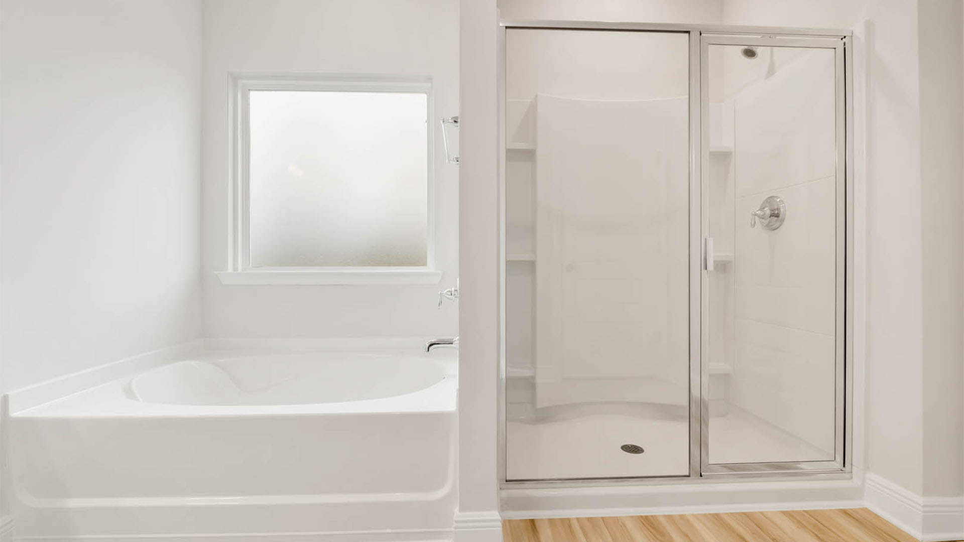 Separate tub and shower with glass door.