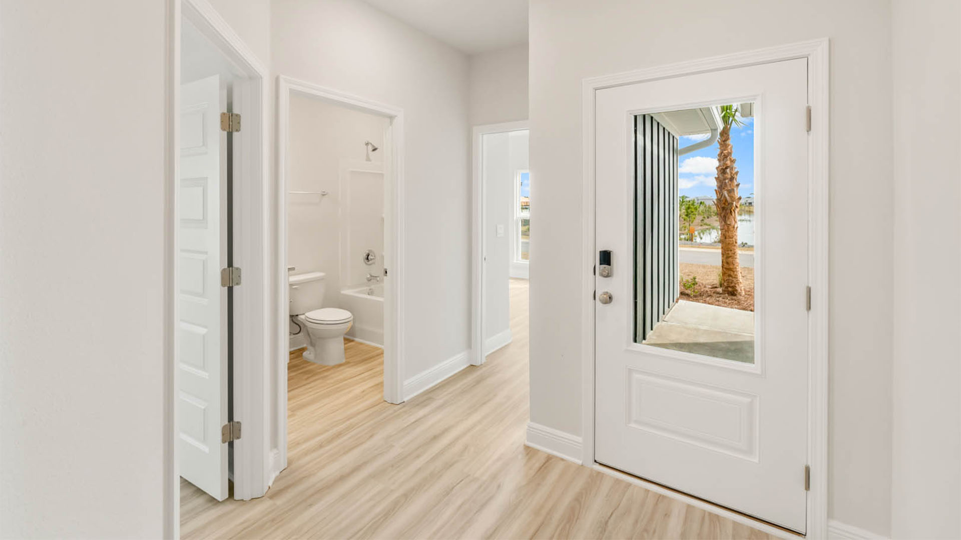 Front door entrance in foyer by bedroom and bathroom.