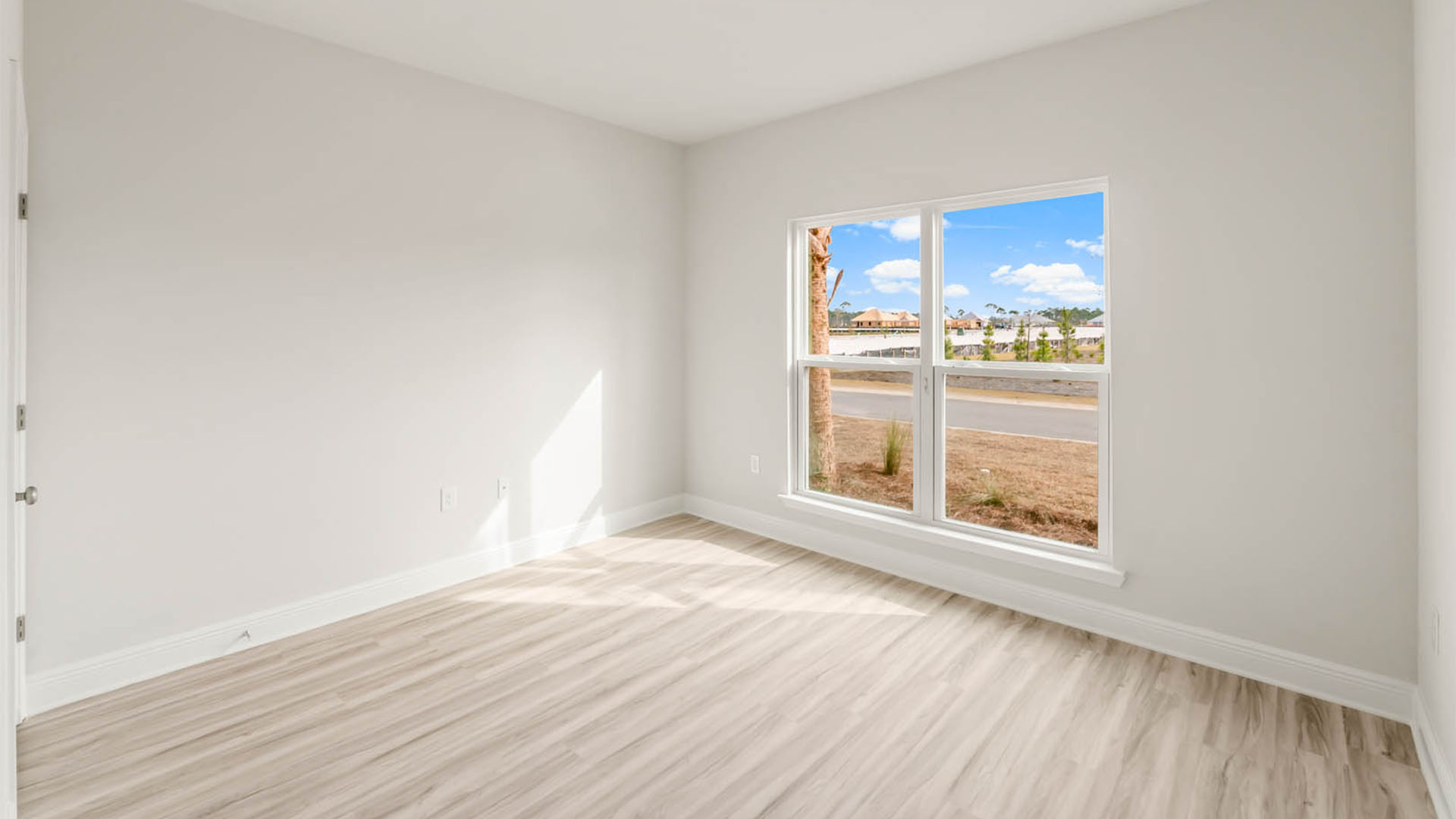 Bedroom with EVP flooring and window.