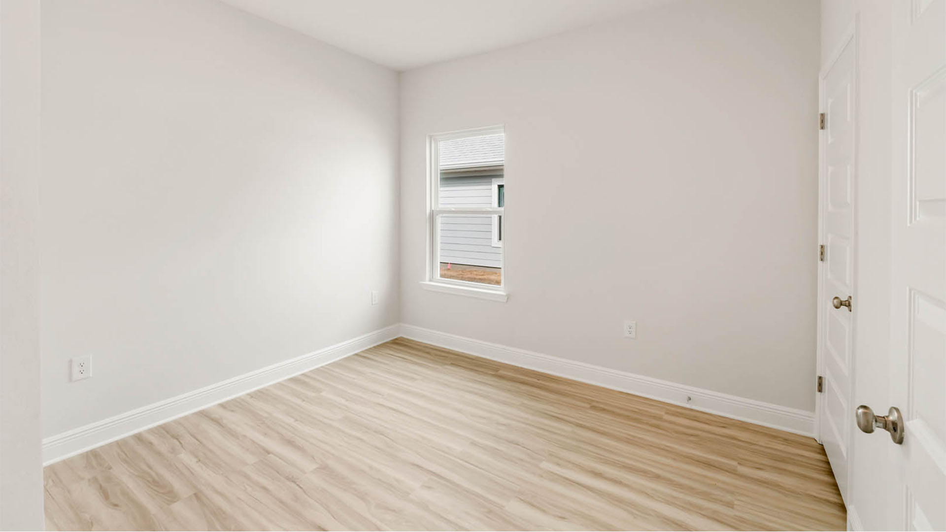 Bedroom with EVP flooring and window.