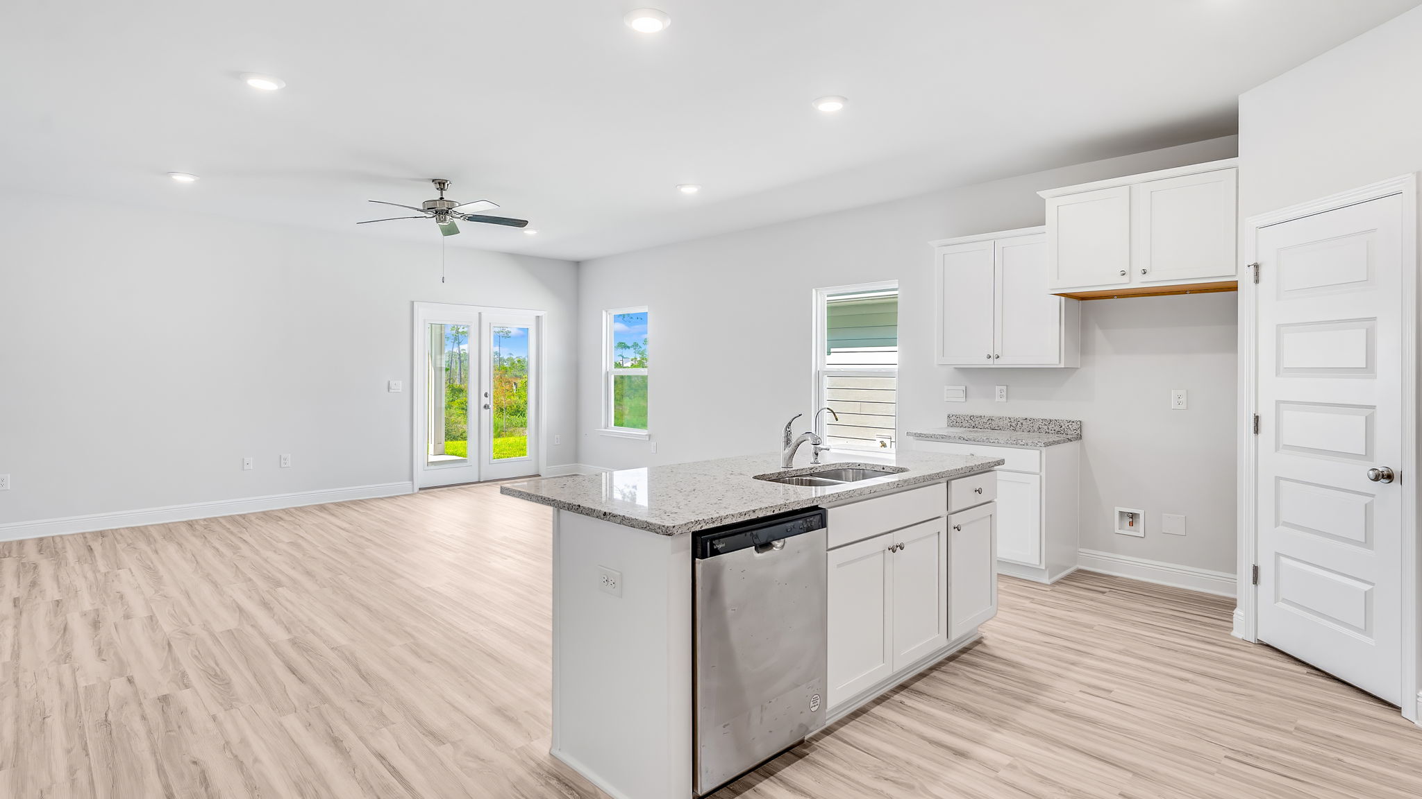 Open kitchen island with granite countertops and living room.