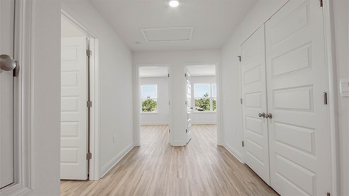 Hallway with EVP flooring and bathroom and bedroom entrances.