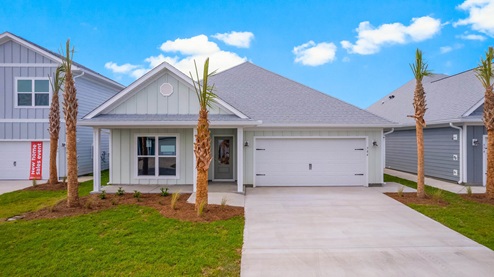 Rhett floor plan at Windmark Beach front of home with two-car garage and covered front porch.