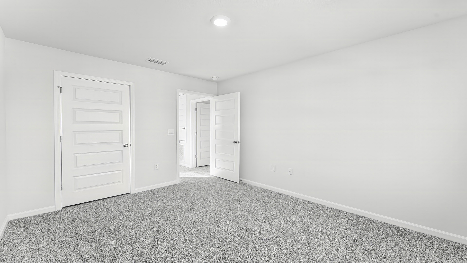 Bedroom with carpet floor and closet.