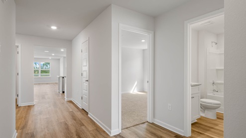 Hallway by bedroom and bathroom with EVP flooring.