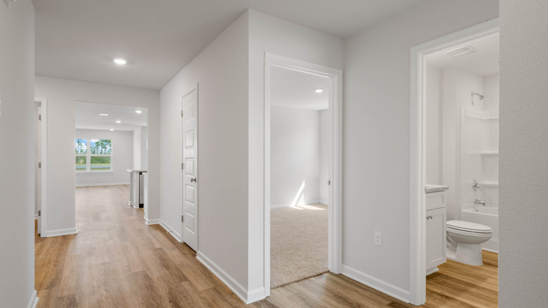 Hallway by bedroom and bathroom with EVP flooring.