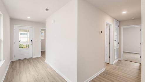 Front door entrance hallway with EVP flooring and hallway to bedrooms.