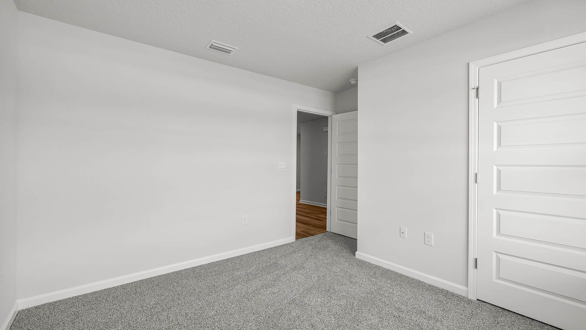 Bedroom with carpet flooring and closet.