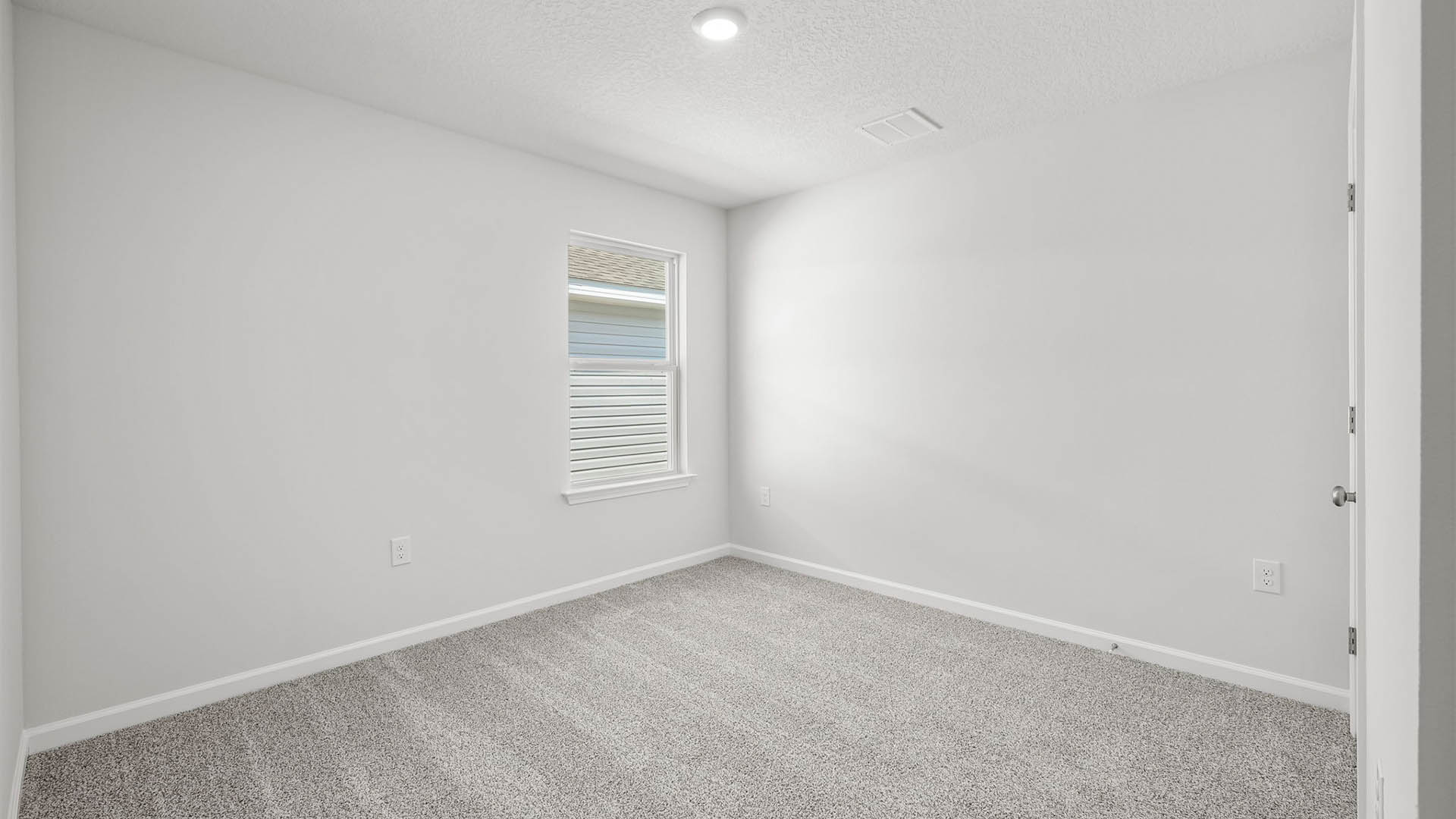 Bedroom with carpet flooring and window and closet.