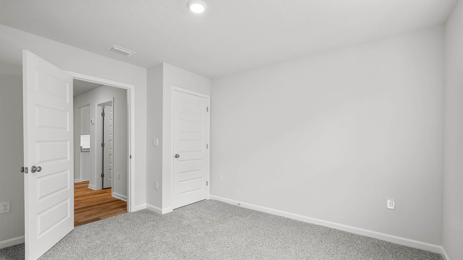 Bedroom with carpet flooring and closet.