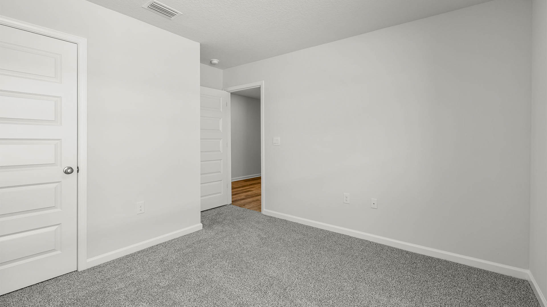 Bedroom with carpet flooring and closet.