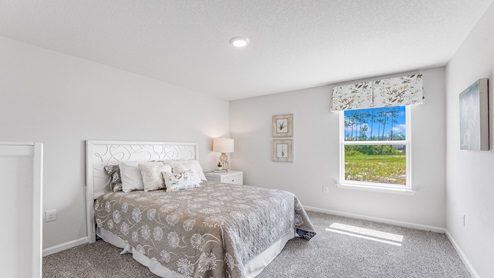 Bedroom with carpet floors and window and closet.