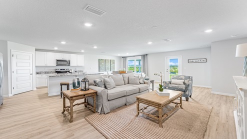 Open living room and kitchen with EVP flooring.