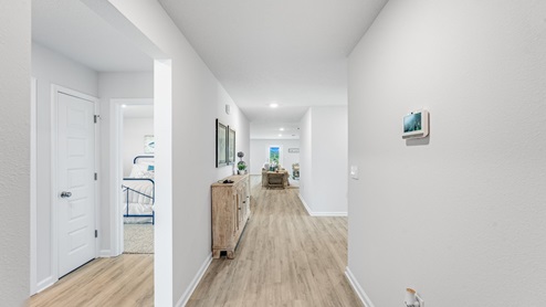Front entrance hallway with EVP flooring next to bedrooms and bathroom.