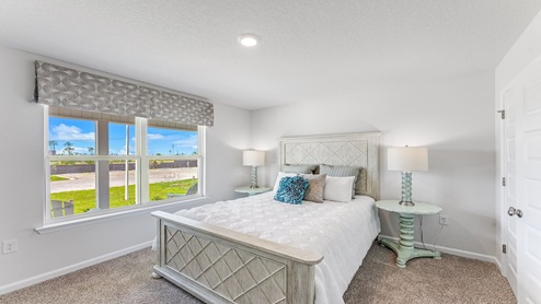 Bedroom with carpet floors and window and closet.