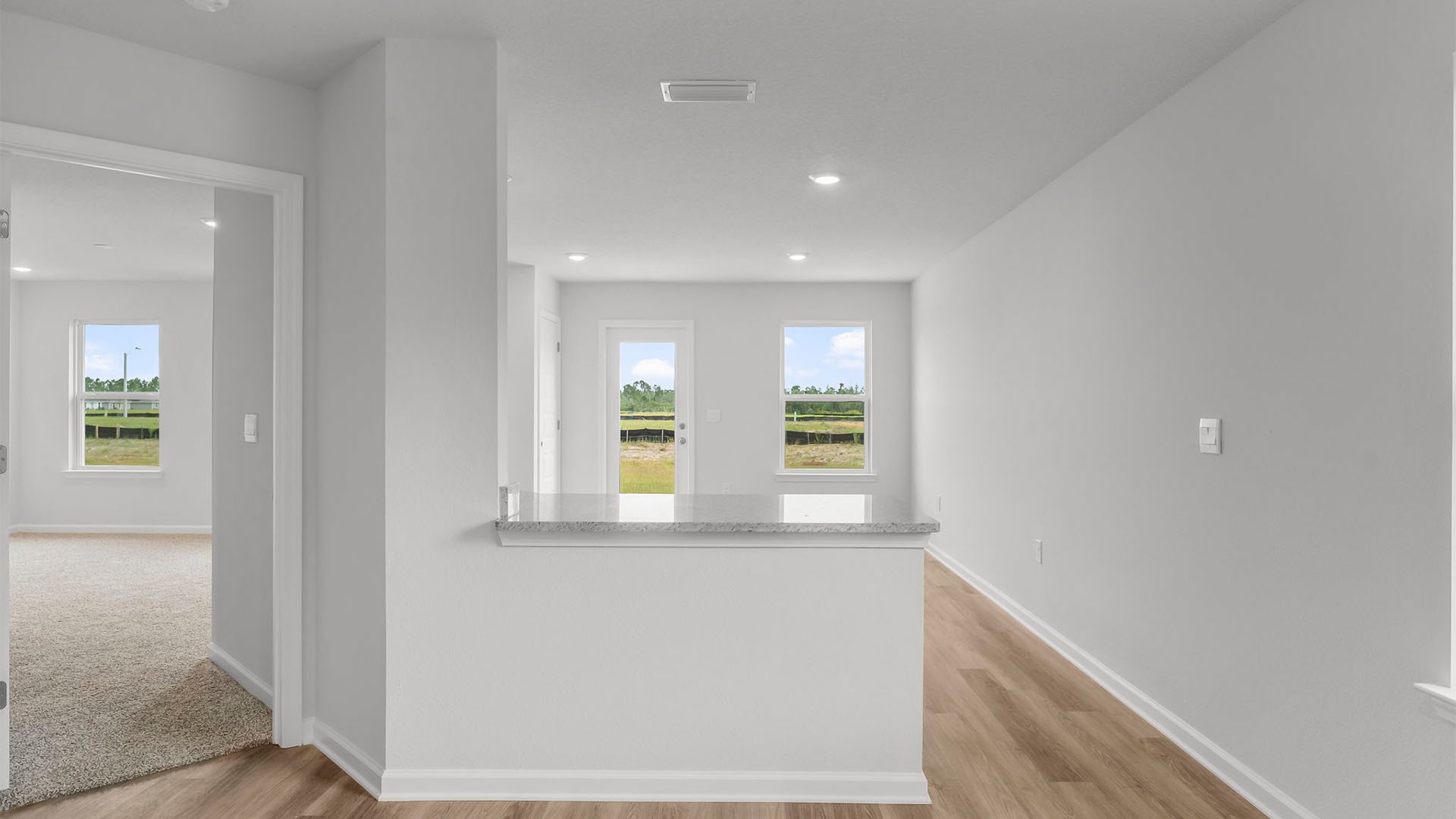Kitchen and primary bedroom entrance.