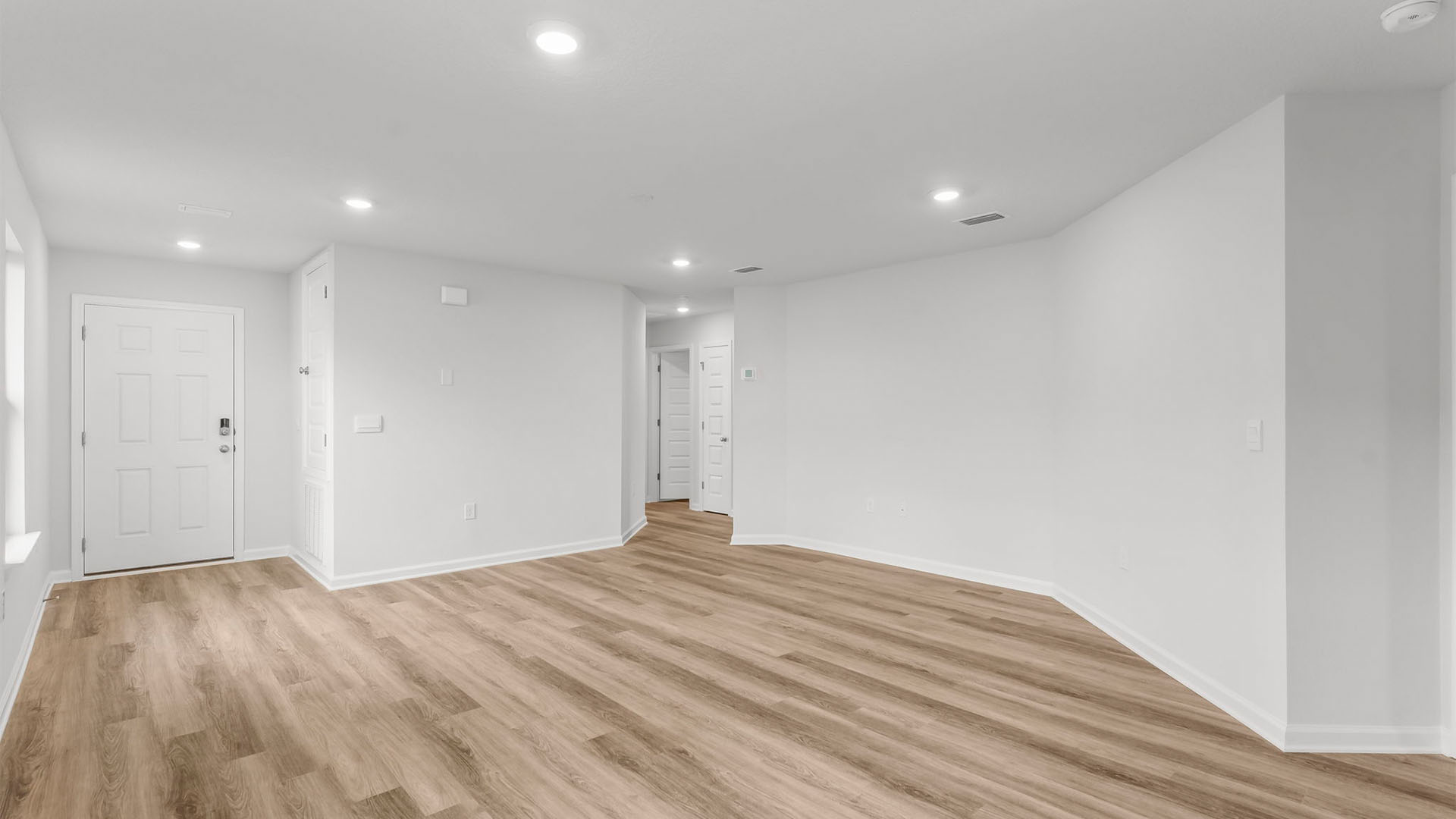 Living room with EVP flooring and hallway.