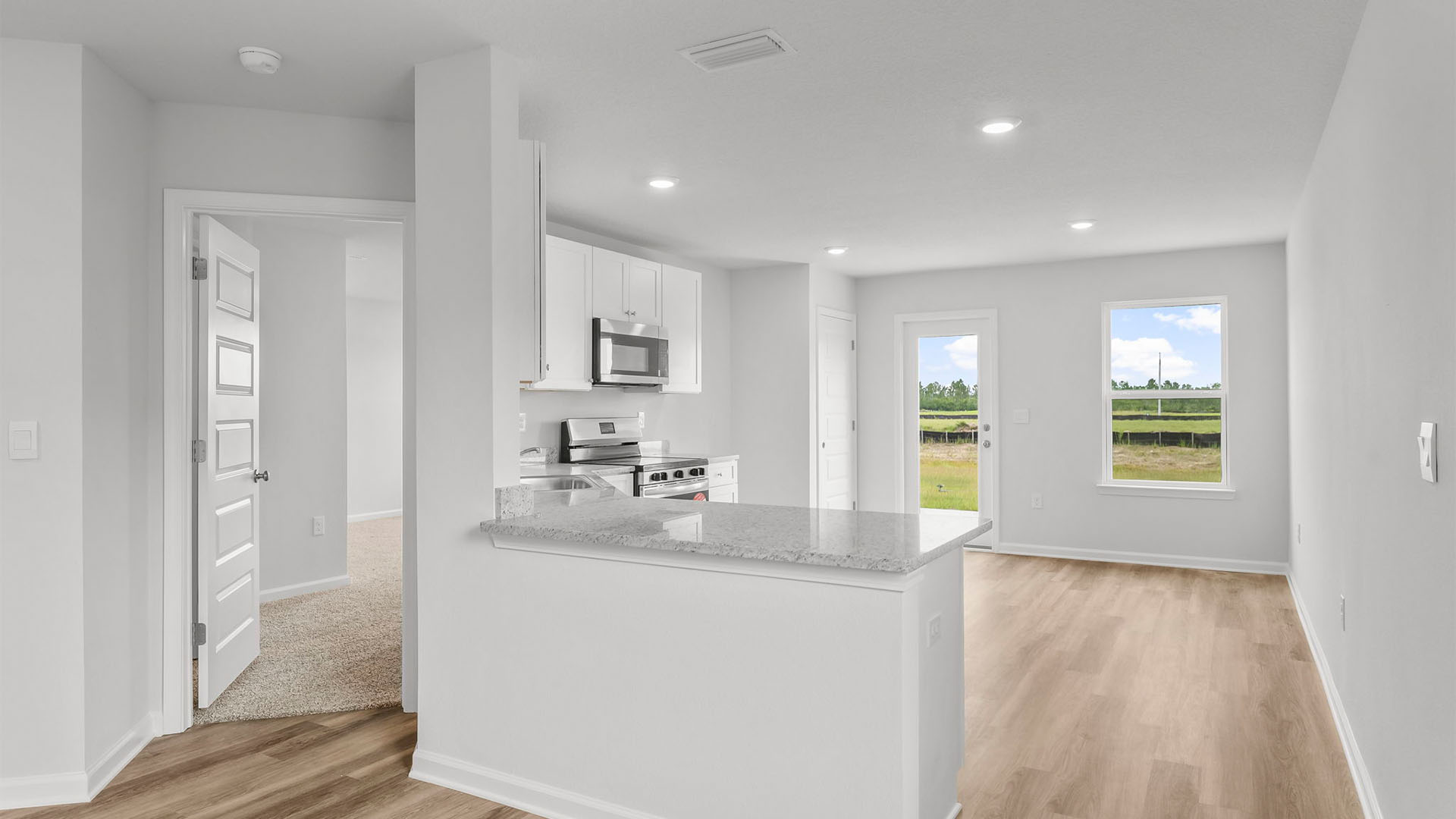 Kitchen and primary bedroom entrance.