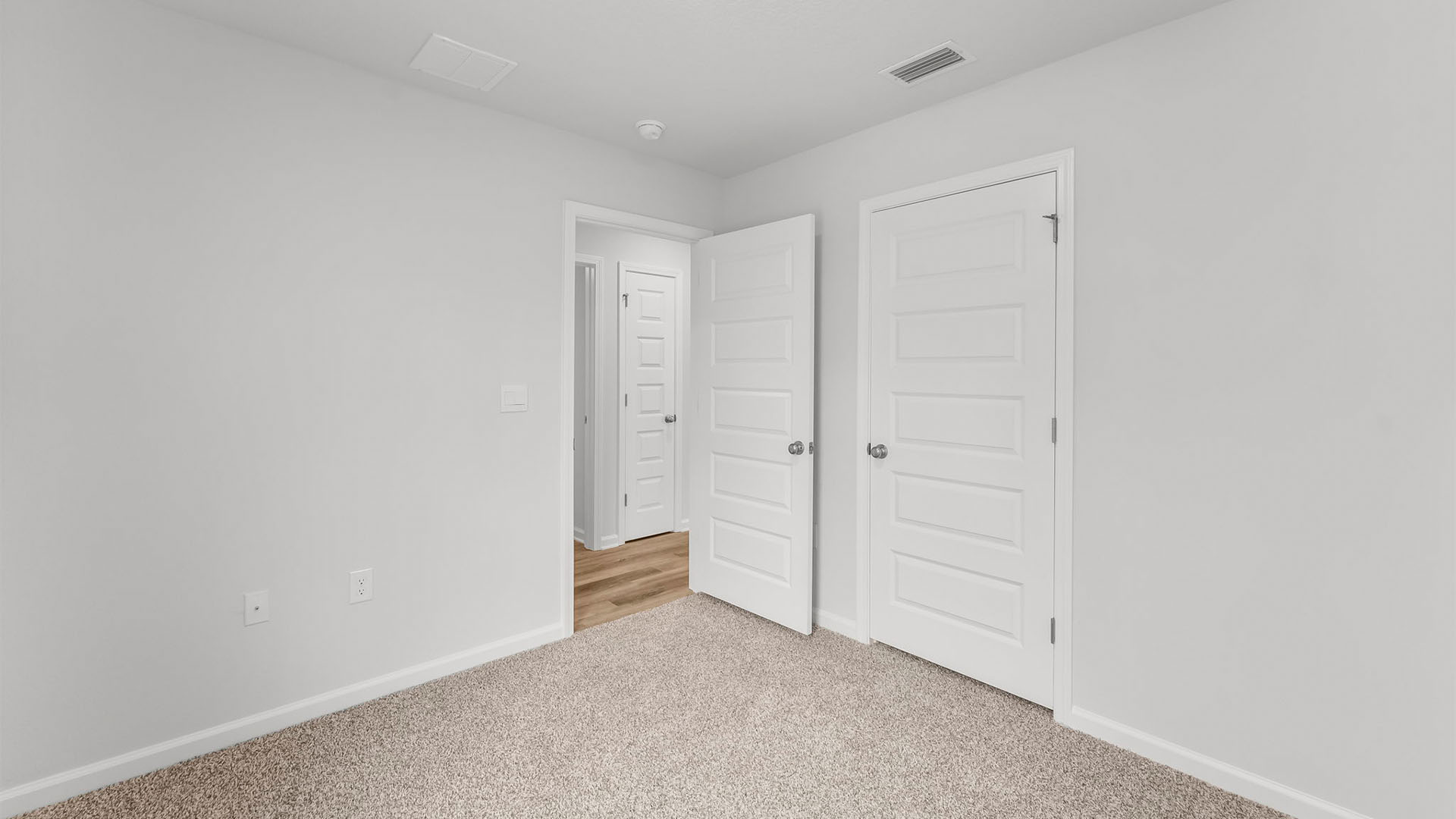 Bedroom with closet and carpet floor.