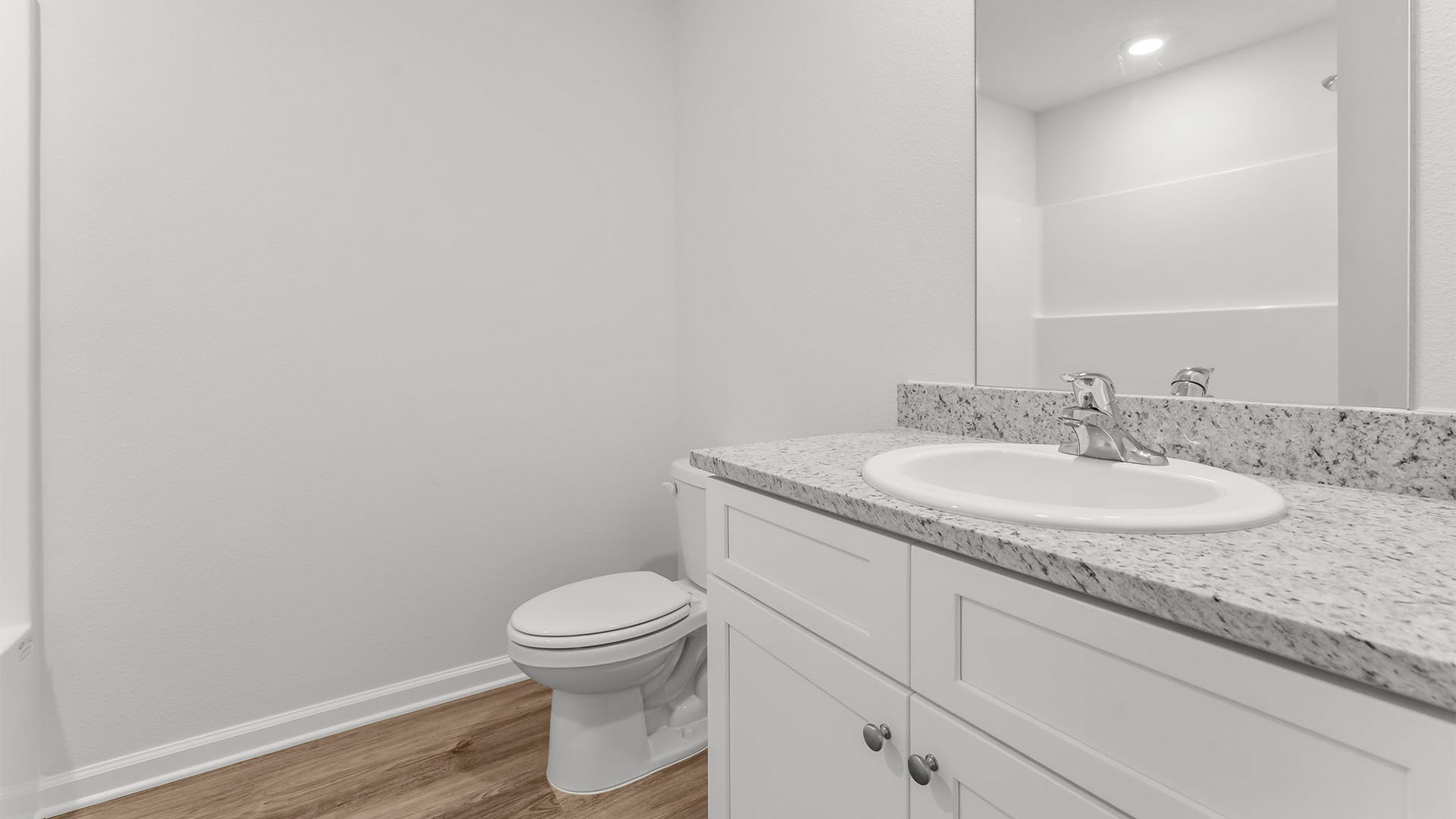 Bathroom with single vanity granite countertop and toilet and shower tub combo.